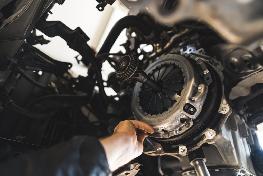 closeup shot of an auto mechanic installing a new clutch kit for a car, auto repair shop