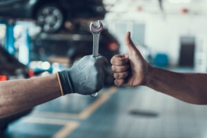 Close-up Thumb Up and Mechanics Hand with Tool