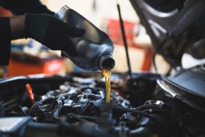 Close up hands of unrecognizable mechanic doing car service and